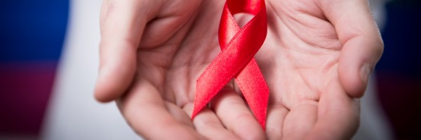 Hand-with-aids-ribbon-slider-600x200